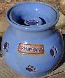 small pet urn with small paw prints
